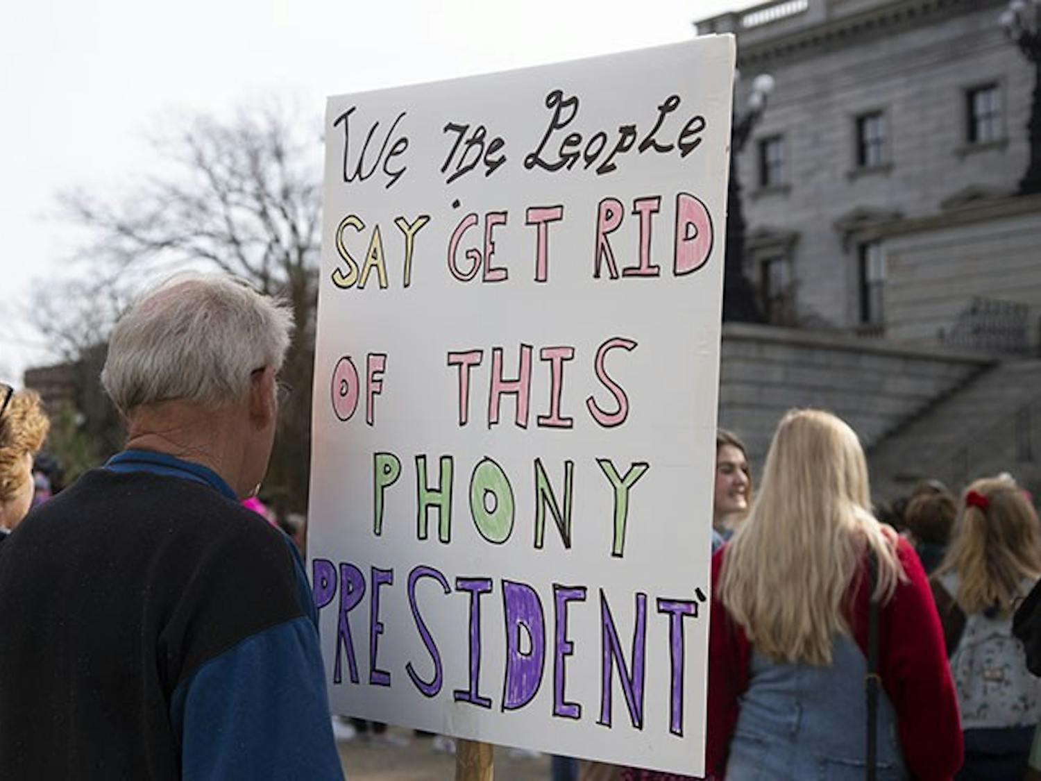 Bruce Sorenson, Retired
The couple from East Over, South Carolina, attended the Women’s March holding signs that showed their opinions on President Trump. Mrs. and Mr. Sorenson believe President Trump is a liar and a phony, as stated on their signs.