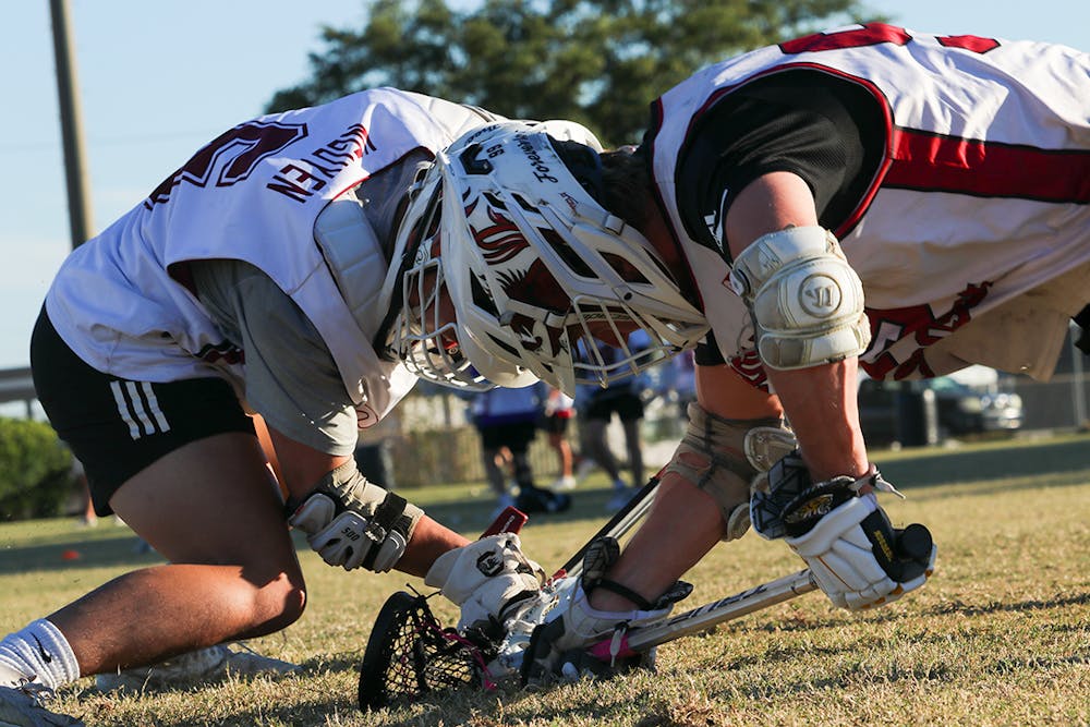 <p>Senior South Carolina men's club lacrosse president Kevin Nguyen practices face-offs against senior Will Frith at the University of South Carolina – Sport’s Club Field on Oct. 5, 2022. The club team plays its first game against James Madison in February 2023.&nbsp;</p>