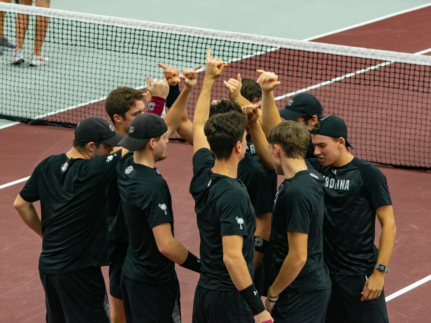 The Men's Tennis team end their team huddle preparing for their matchups on Feb. 4, 2022. The team will face their first ranked opponent, Wake Forest, on Feb. 10.