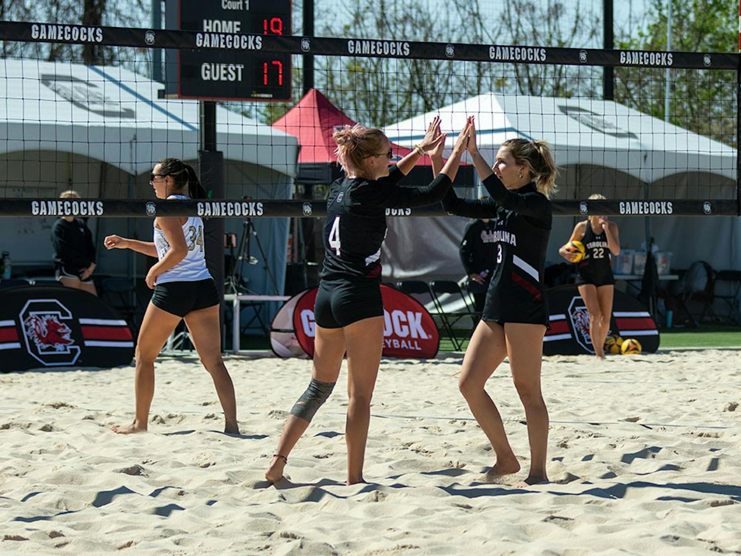 Junior Hailey Cabeceiras and junior Sophie Manson congratulate each other after a point at Wheeler Beach on April 2, 2022. South Carolina won three out of for games in the Carolina Challenger.