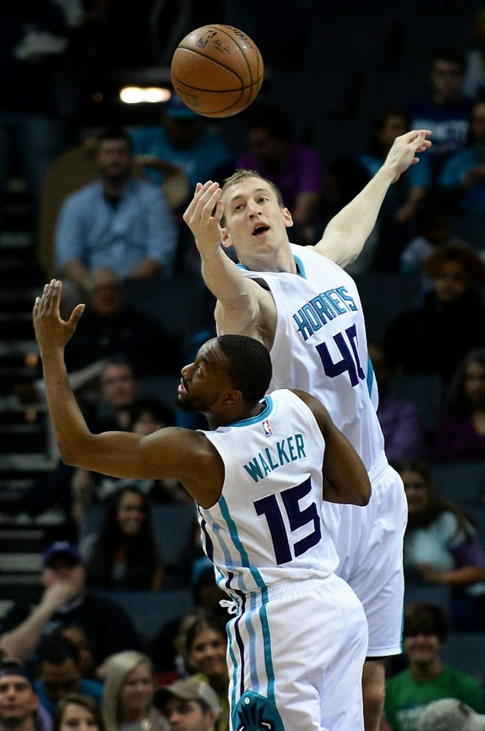 The Charlotte Hornets' Cody Zeller, top, fights for control of a rebound with teammate Kemba Walker (15) during first-half action against the Denver Nuggets on Friday, March 31, 2017, at the Spectrum Center in Charlotte, N.C. (Jeff Siner/Charlotte Observer/TNS)