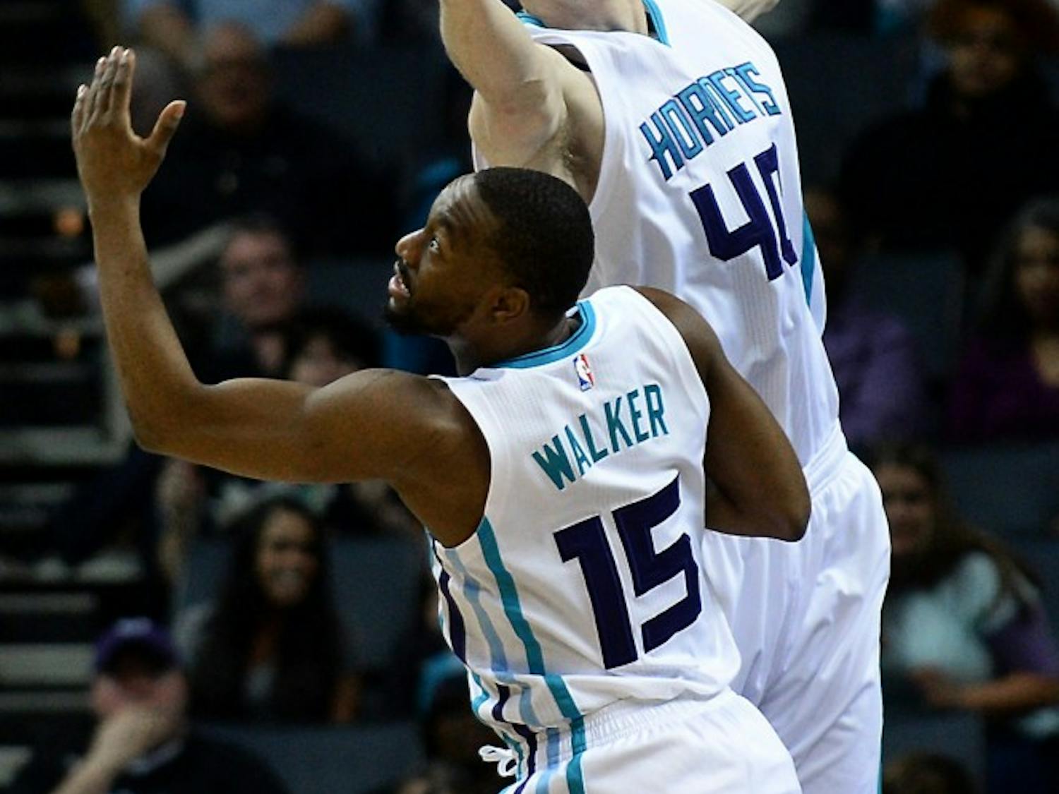 The Charlotte Hornets' Cody Zeller, top, fights for control of a rebound with teammate Kemba Walker (15) during first-half action against the Denver Nuggets on Friday, March 31, 2017, at the Spectrum Center in Charlotte, N.C. (Jeff Siner/Charlotte Observer/TNS)