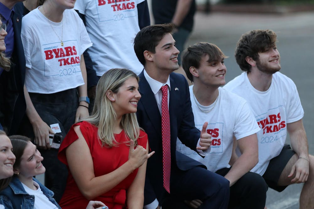 <p>Third-year political science student Patton Byars and second-year public health and political science student Courtney Tkacs pose for a photo with their team following the announcement of the Student Government election results on Feb. 21, 2024. Tkacs and Byars campaigned together as running mates for the election.</p>