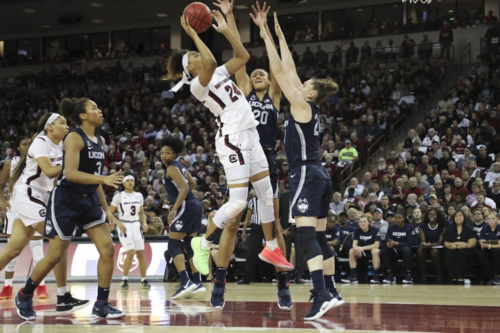 Junior guard Lele Grissett goes up for a shot while UConn players attempt to block her. Grissett scored 2 points against the Huskies.