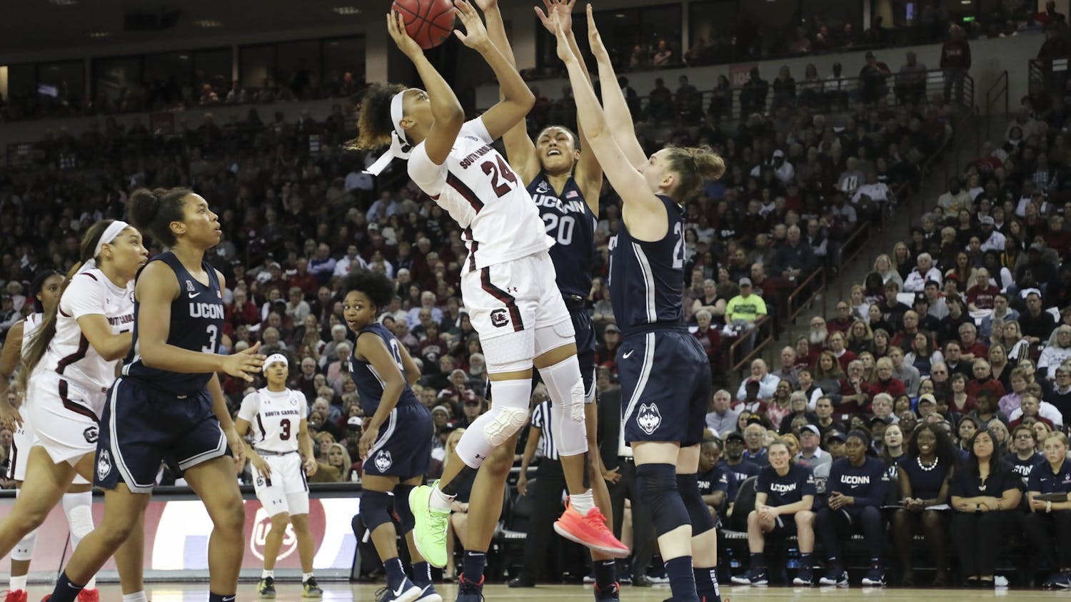 Junior guard Lele Grissett goes up for a shot while UConn players attempt to block her. Grissett scored 2 points against the Huskies.