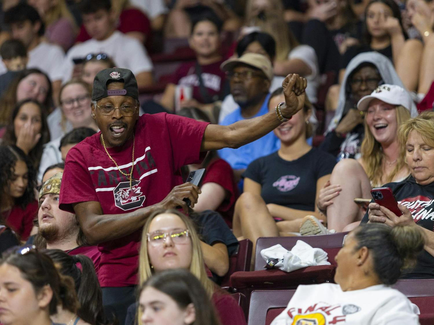 A Gamecock fan dances to music at Colonial Life Arena on April 8, 2024. Students and Columbia natives gathered to rewatch the championship game and welcome the Gamecocks home.