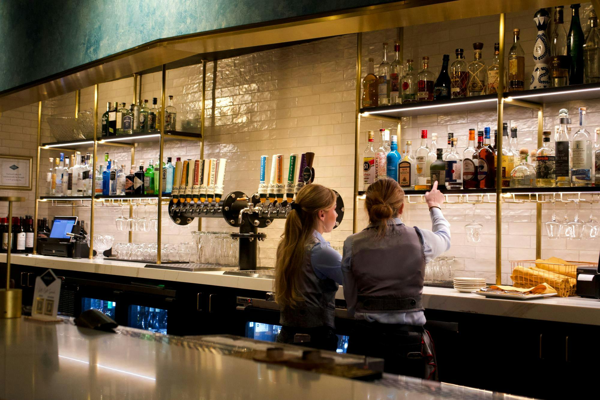 Staff members work behind the bar at Smoked, located at 1643 Main St. in Columbia, South Carolina on Jan. 8, 2024. Smoked offers a variety of signature cocktails, in-house brewed beer and fine wines.