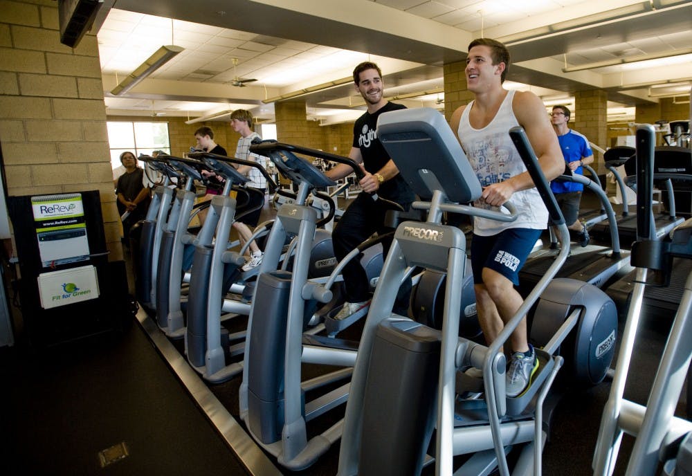 Instructor Kevin Brostoff, left, and student Jared Olivo generate electricity as they workout on elliptical trainers at at the Anteater Recreation Center at the University of California, Irvine, on January 20, 2012. Using gym equipment, Fit for Green makes a game out of the creation of renewable energy in the gym, using social media as a platform. (Paul Rodriguez/Orange County Register/MCT)