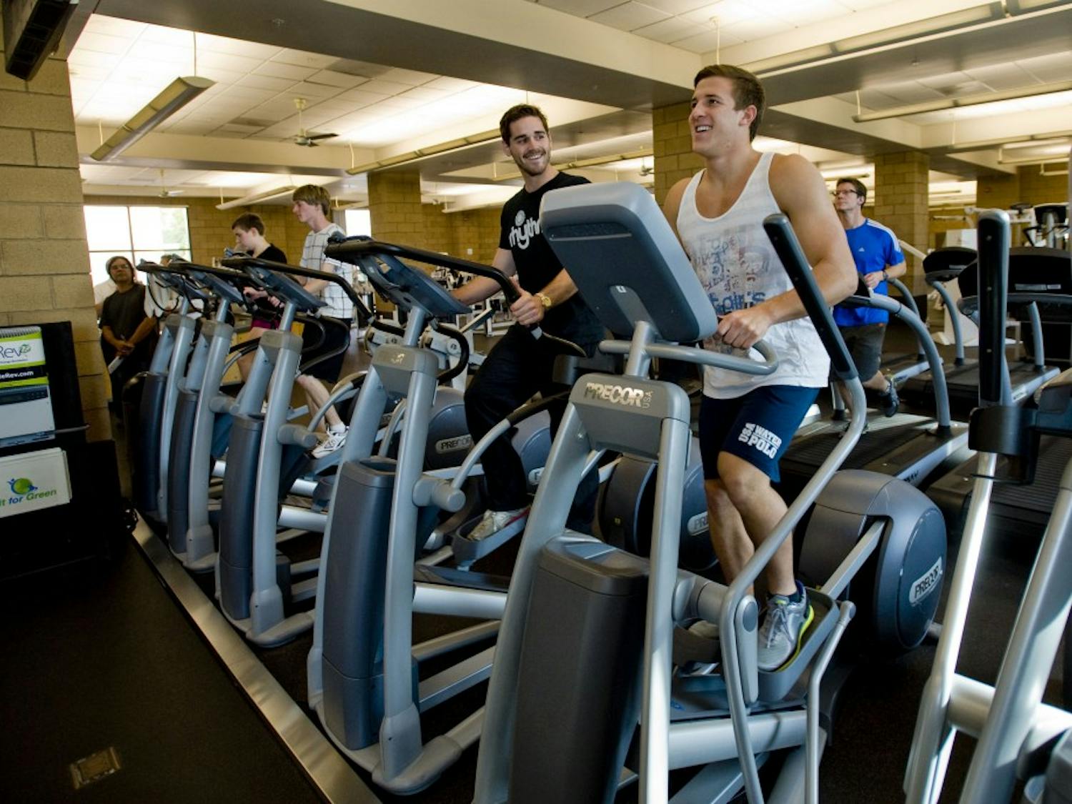 Instructor Kevin Brostoff, left, and student Jared Olivo generate electricity as they workout on elliptical trainers at at the Anteater Recreation Center at the University of California, Irvine, on January 20, 2012. Using gym equipment, Fit for Green makes a game out of the creation of renewable energy in the gym, using social media as a platform. (Paul Rodriguez/Orange County Register/MCT)