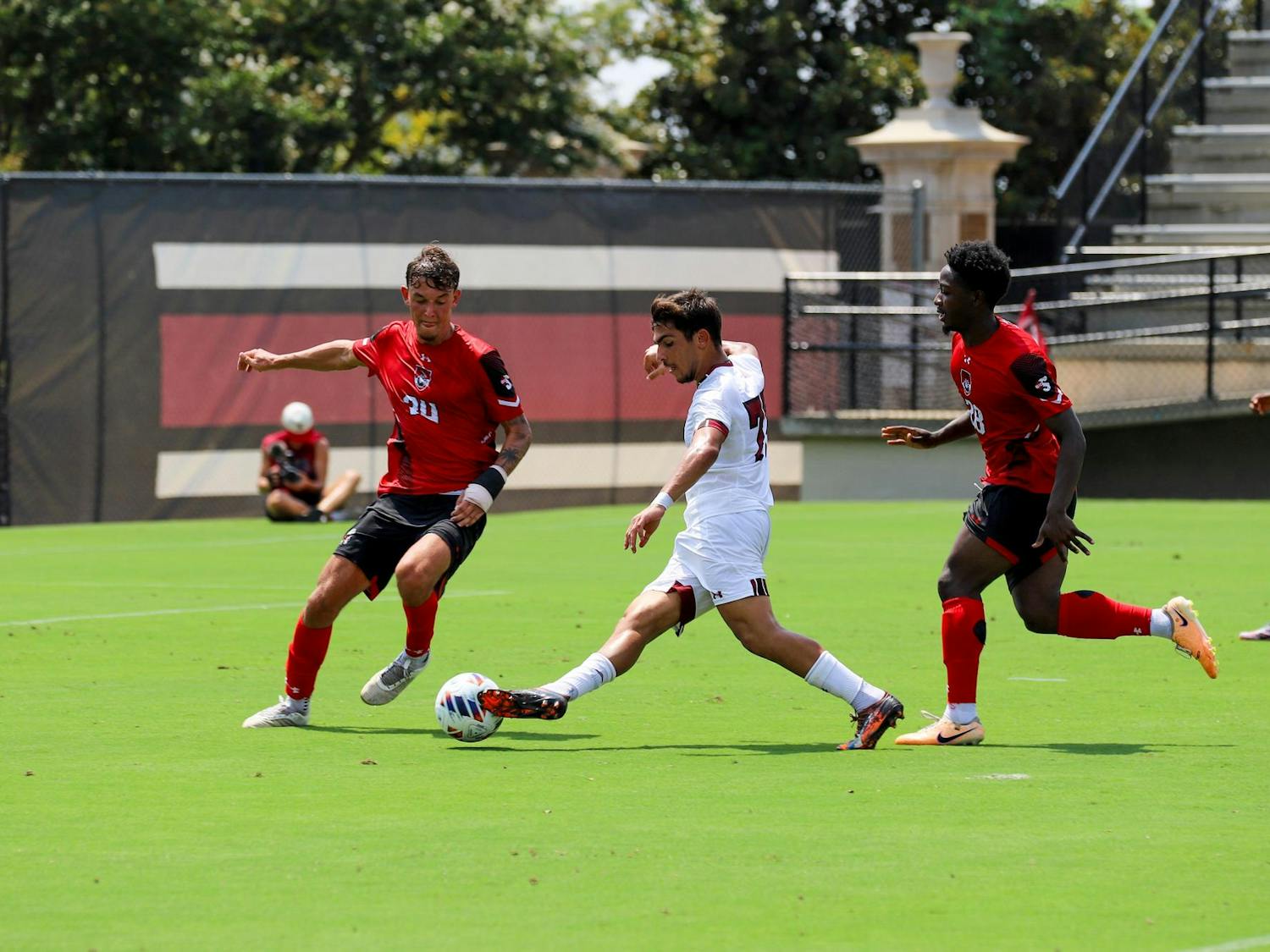 Freshman midfielder Pantelis Gavriel passes the ball to one of his teammates as he gets double-teamed close to Gardner-Webb's goal. The Gamecocks fell to the Bulldogs 2-0 in its first home game of the season.