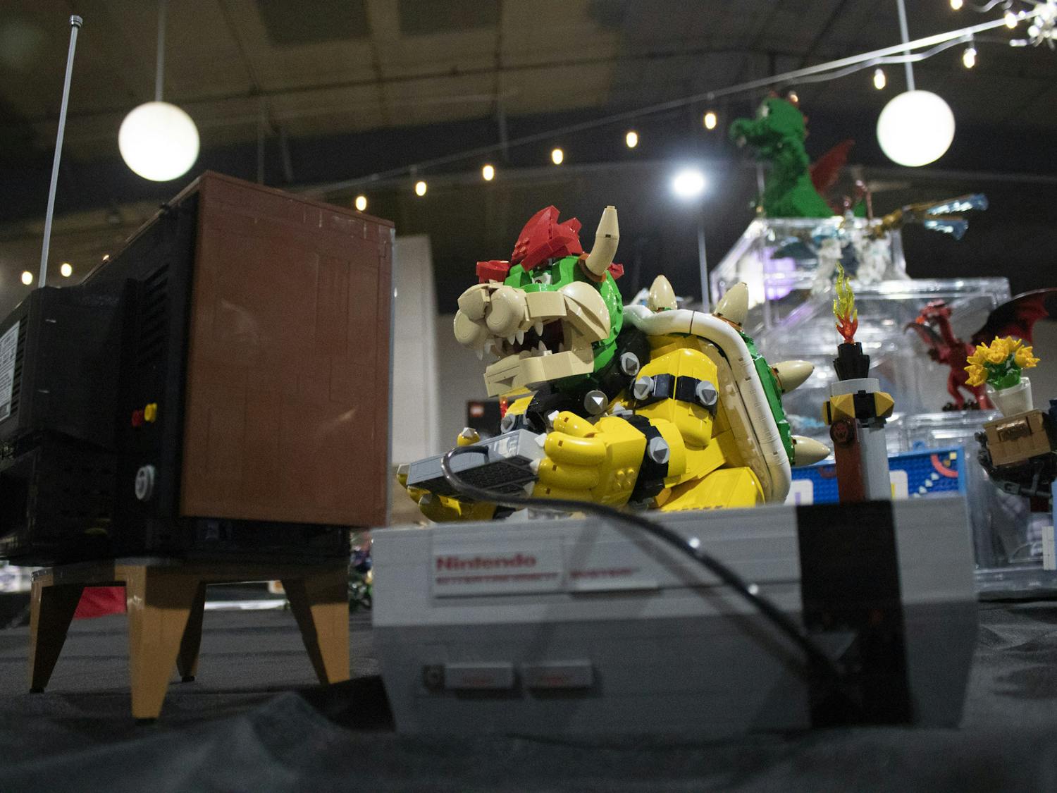 Nintendo’s Bowser Lego set enjoys himself at Columbia Brick Con by playing the LEGO Duck Hunt and LEGO Nintendo 64 sets on March 25, 2023. Many official LEGO sets were put on display as well as free-builds from exhibitors.&nbsp;