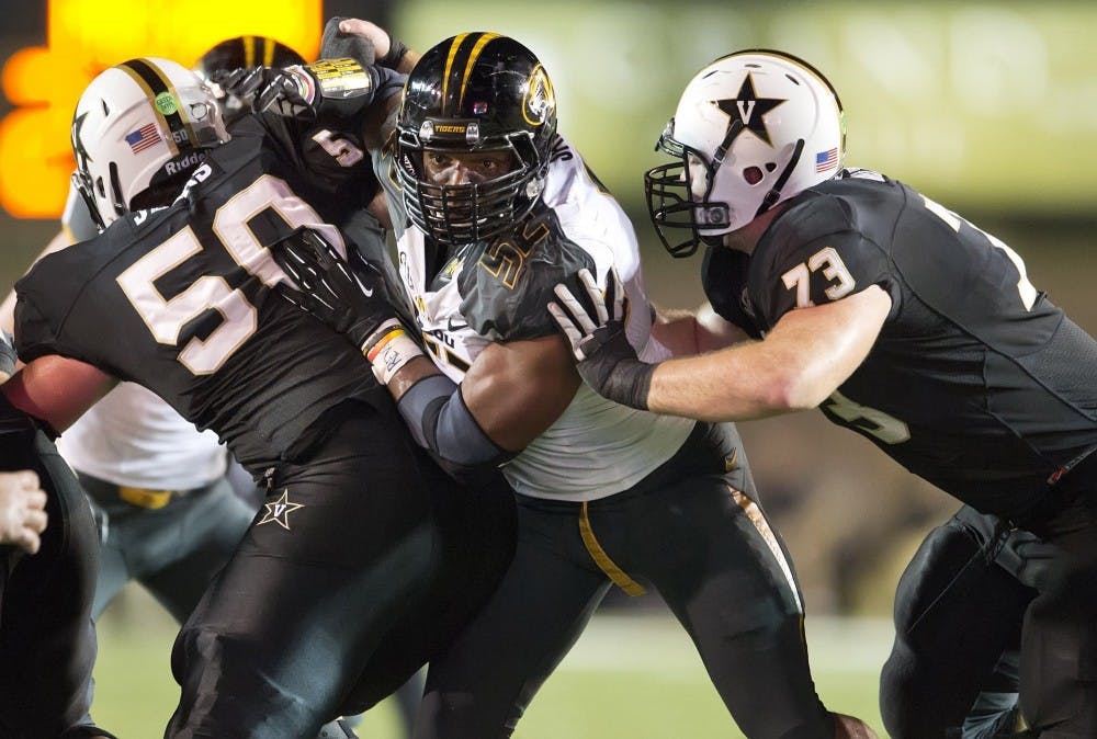 Missouri Tigers defensive lineman Michael Sam, center, on Sunday, Feb. 9, 2014, became the most prominent, and apparently the first, active male athlete on the major U.S. sports scene to publicly disclose that he's gay. Sam is seen during a college football game against Vanderbilt in this October 5, 2013, file photo. (David Eulitt/Kansas City Star/MCT)