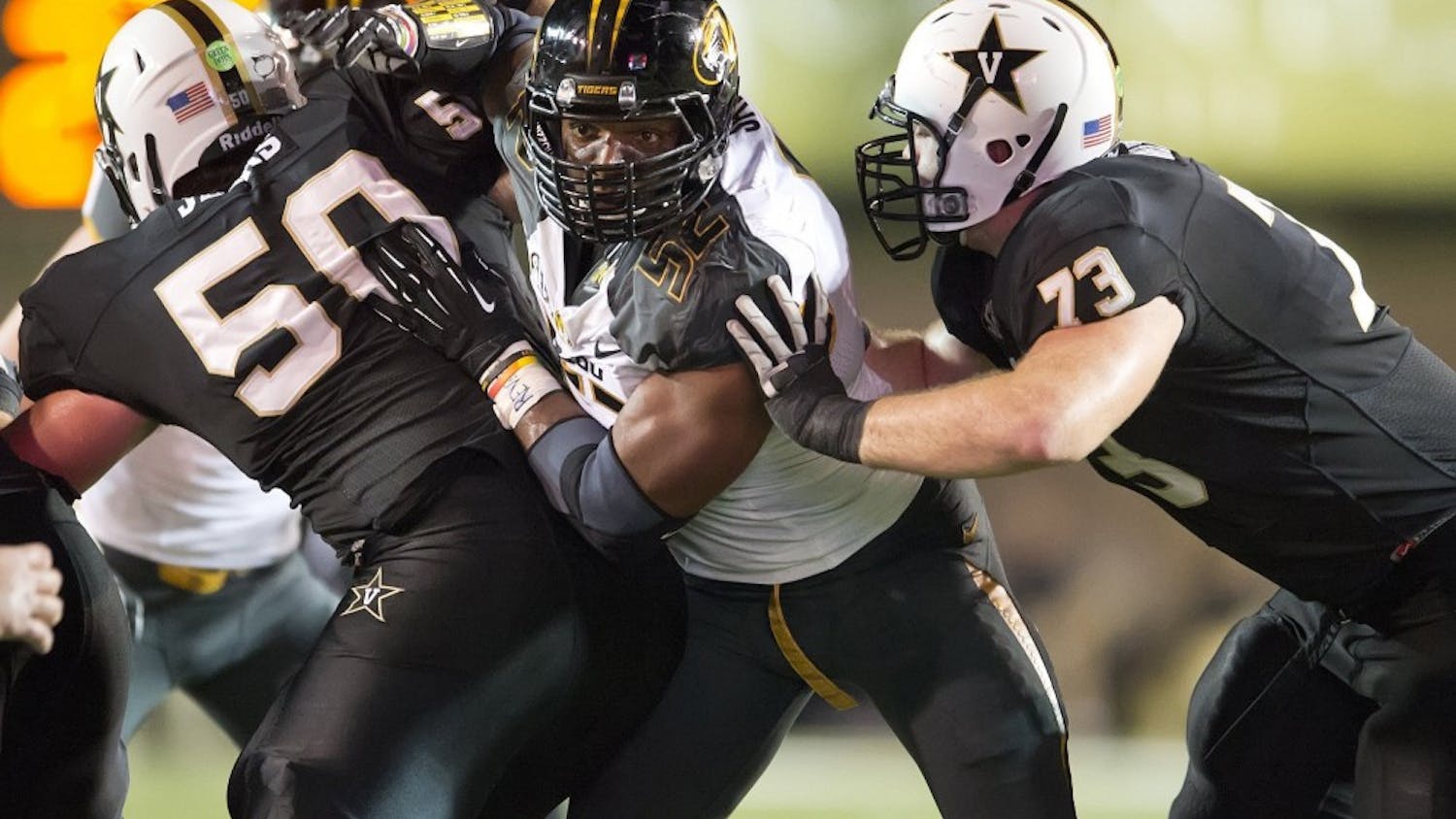Missouri Tigers defensive lineman Michael Sam, center, on Sunday, Feb. 9, 2014, became the most prominent, and apparently the first, active male athlete on the major U.S. sports scene to publicly disclose that he's gay. Sam is seen during a college football game against Vanderbilt in this October 5, 2013, file photo. (David Eulitt/Kansas City Star/MCT)