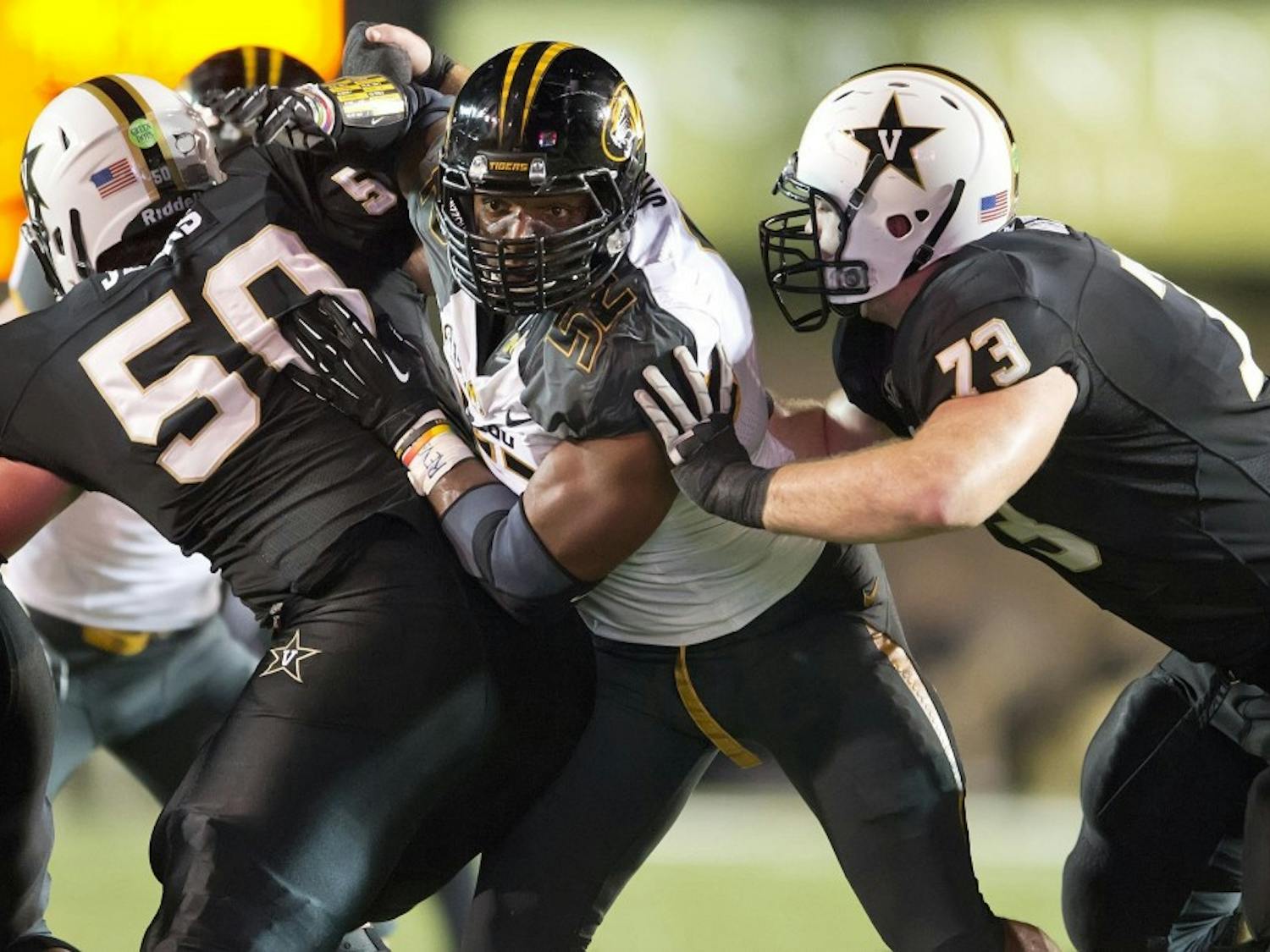 Missouri Tigers defensive lineman Michael Sam, center, on Sunday, Feb. 9, 2014, became the most prominent, and apparently the first, active male athlete on the major U.S. sports scene to publicly disclose that he's gay. Sam is seen during a college football game against Vanderbilt in this October 5, 2013, file photo. (David Eulitt/Kansas City Star/MCT)