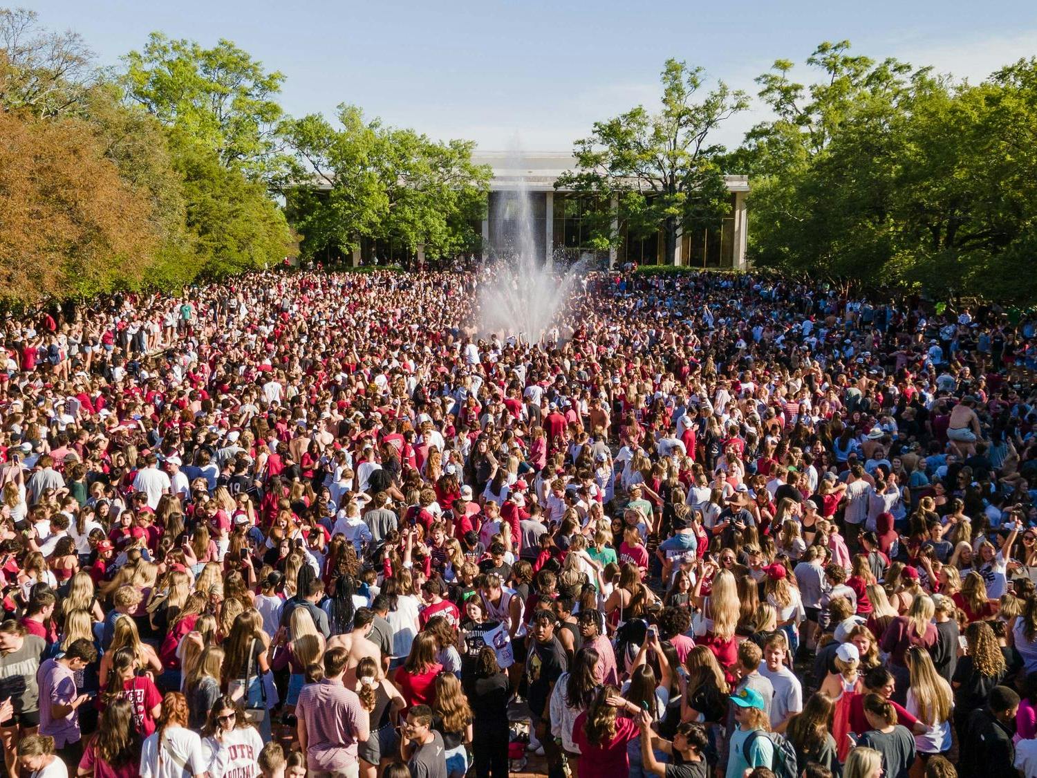 South Carolina Gamecock students swarm the Thomas Cooper Fountain and Reflecting Pool within minutes of the Gamecocks' 87-75 win against the Iowa Hawkeyes on April 7, 2024. The victory marks the Gamecocks' third NCAA championship win.