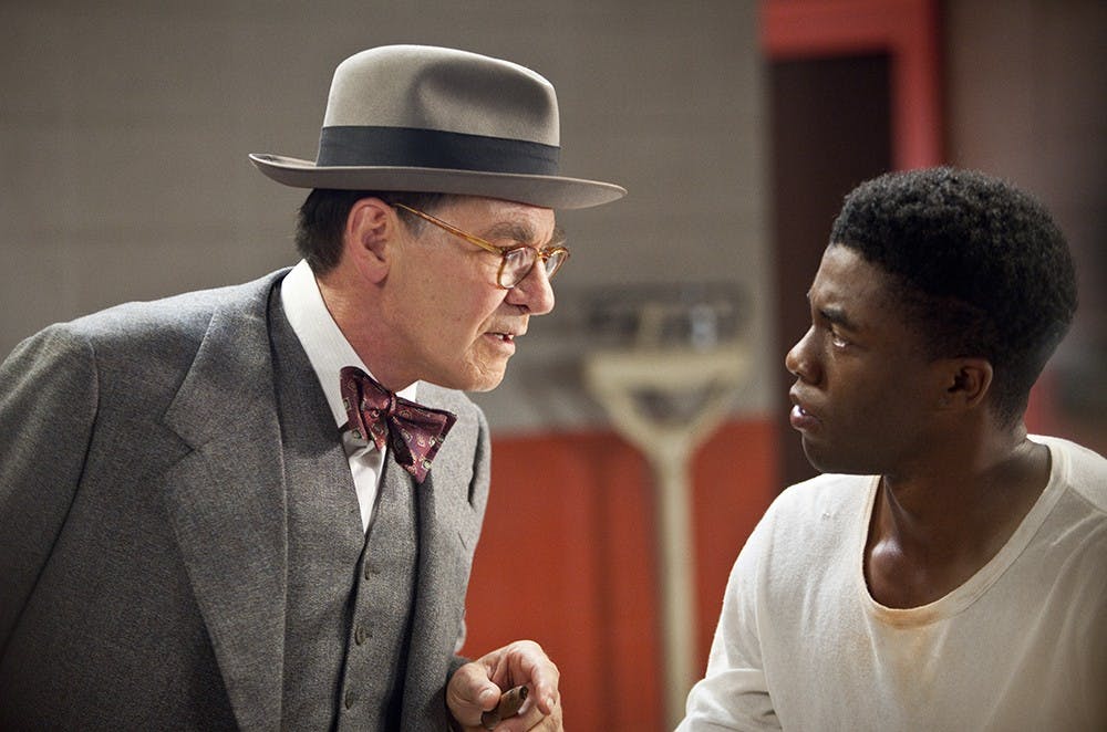 Harrison Ford, left, as Branch Rickey and Chadwick Boseman (right) as Jackie Robinson are seen in Warner Bros. Pictures and Legendary Pictures drama &quot;42,&quot; a Warner Bros. Pictures release. (D. Stevens/Warner Bros/MCT)