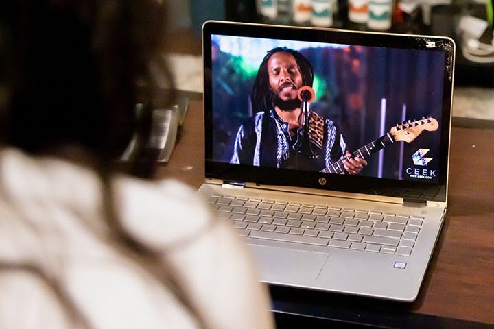 &nbsp;A person sits on their couch while streaming a concert on their laptop. Live-stream concerts became popular during the COVID-19 pandemic as they provided a safe way to attend and enjoy music entertainment.&nbsp;