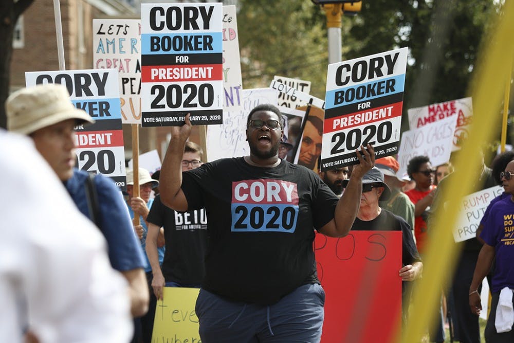Protestors march with Cory Booker 2020 posters on their way to Benedict College on Oct. 25.&nbsp;