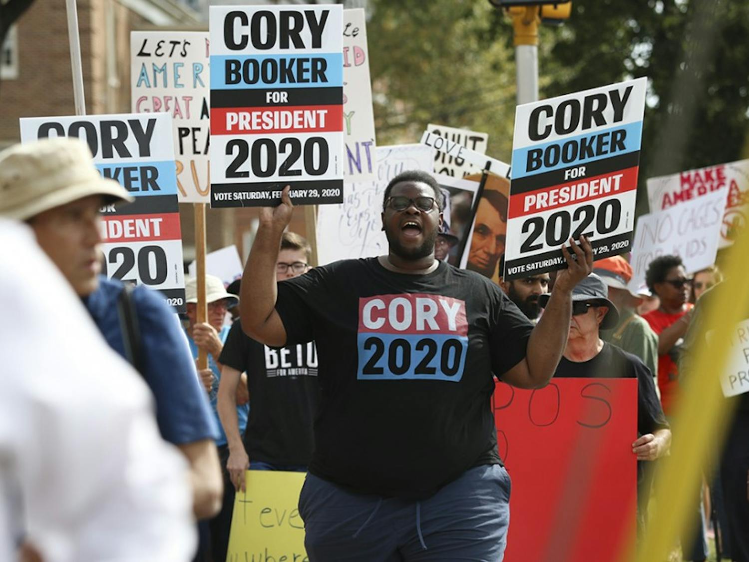 Protestors march with Cory Booker 2020 posters on their way to Benedict College on Oct. 25.&nbsp;