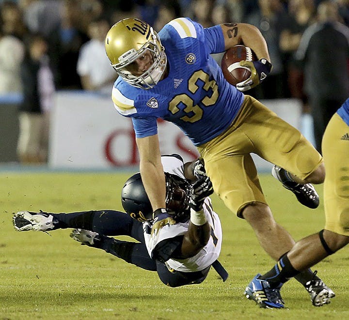 UCLA running back Steven Manfro (33) eludes a tackle by Cal cornerback Adrian Lee in the first quarter on Saturday, October 12, 2013, 2013, at the Rose Bowl in Pasadena, California. (Luis Sinco/Los Angeles Times/MCT)