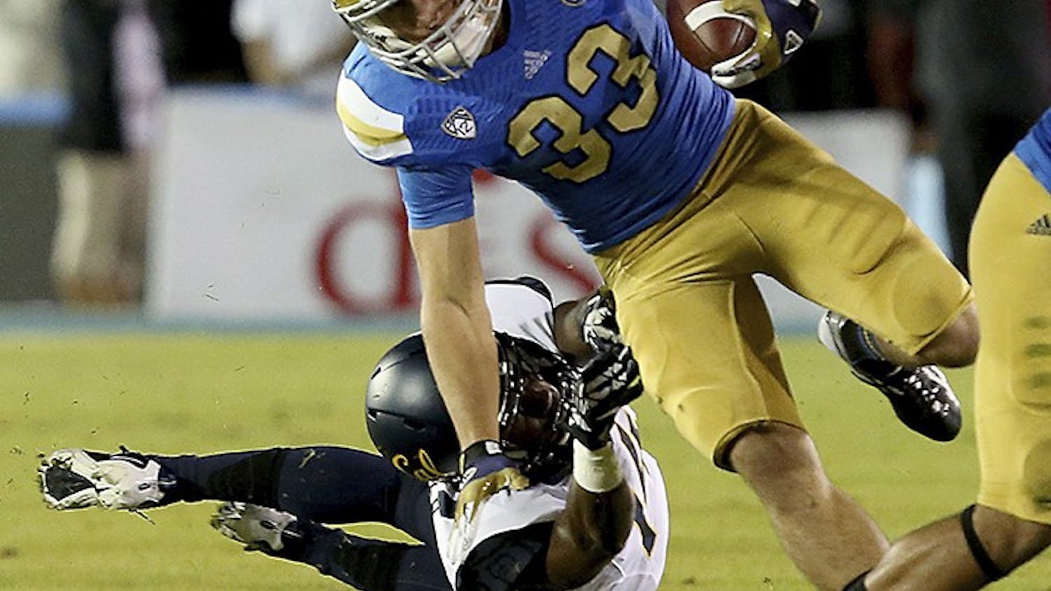 UCLA running back Steven Manfro (33) eludes a tackle by Cal cornerback Adrian Lee in the first quarter on Saturday, October 12, 2013, 2013, at the Rose Bowl in Pasadena, California. (Luis Sinco/Los Angeles Times/MCT)