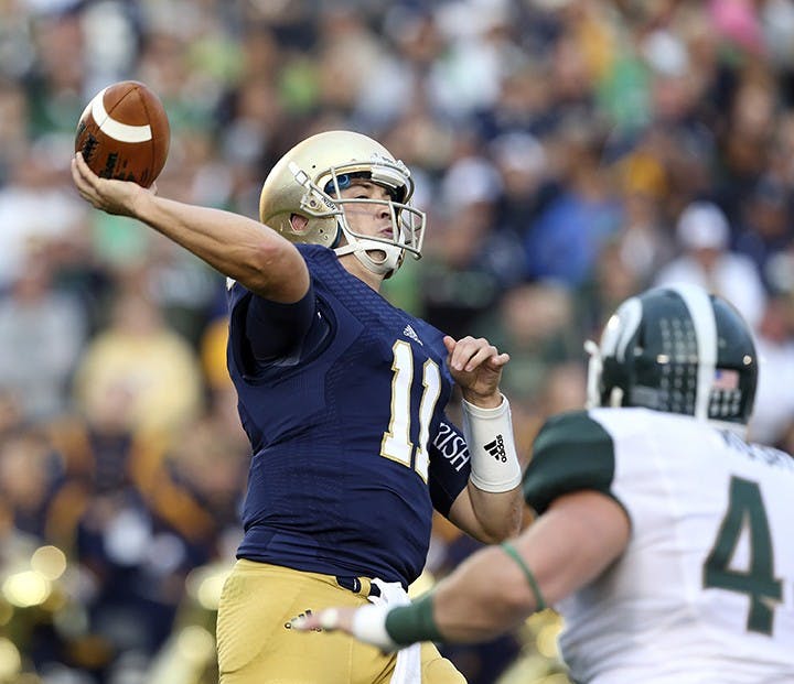 Notre Dame quarterback Tommy Rees (11) throws a pass late in the second half against Michigan State at Notre Dame Stadium in South Bend, Indiana, on Saturday, September 21, 2013. The Fighting Irish won, 17-14. (Nuccio DiNuzzo/Chicago Tribune/MCT)