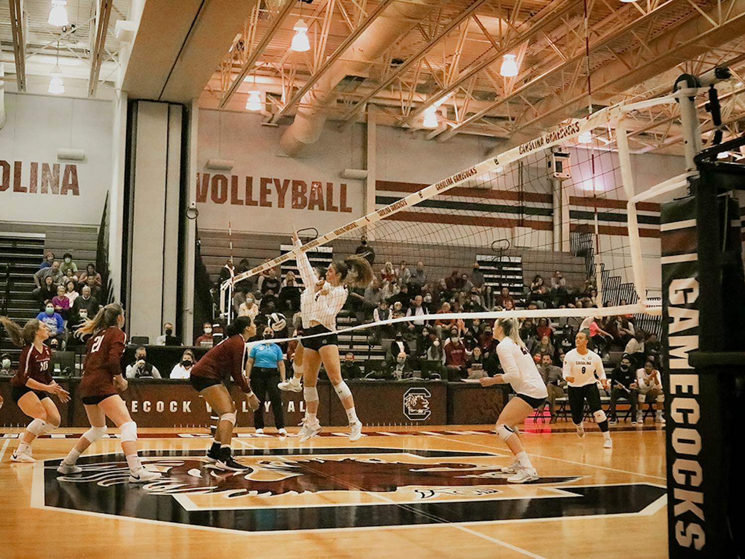 The players block a hit from the Arkansas Razorbacks and score. The Women’s Volleyball team goes on to lose to the Razorbacks in all 3 sets.&nbsp;