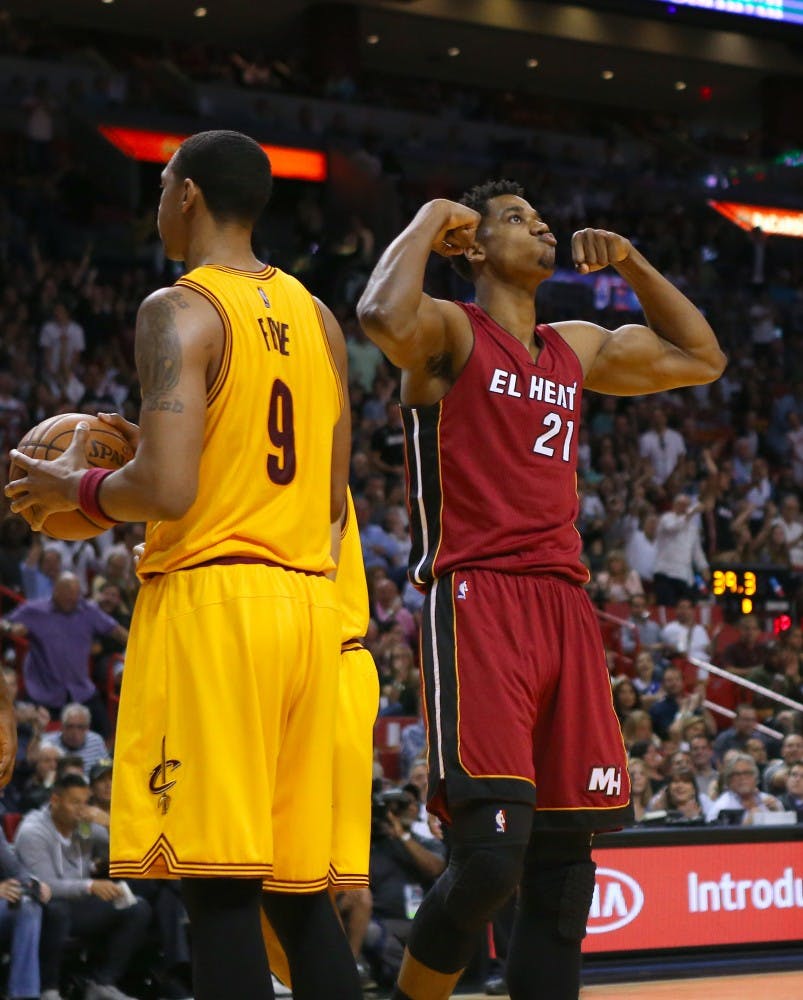 The Miami Heat's Hassan Whiteside, right, reacts after a play during the first quarter against the Cleveland Cavaliers at the AmericanAirlines Arena in Miami on Saturday, March 19, 2016. The Heat won, 122-101. (David Santiago/El Nuevo Herald/TNS)
