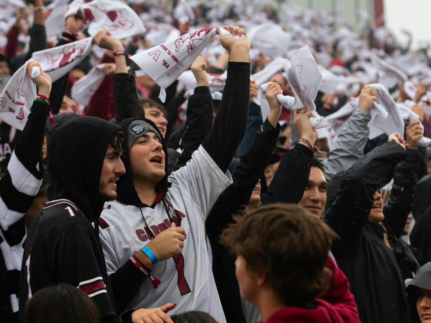 Students wave their rally towels as he song "Sandstorm" by Darude plays across Williams-Brice Stadium. Fans gathered in the rain Saturday to watch the SEC matchup between the Gamecocks and the Commodores.
