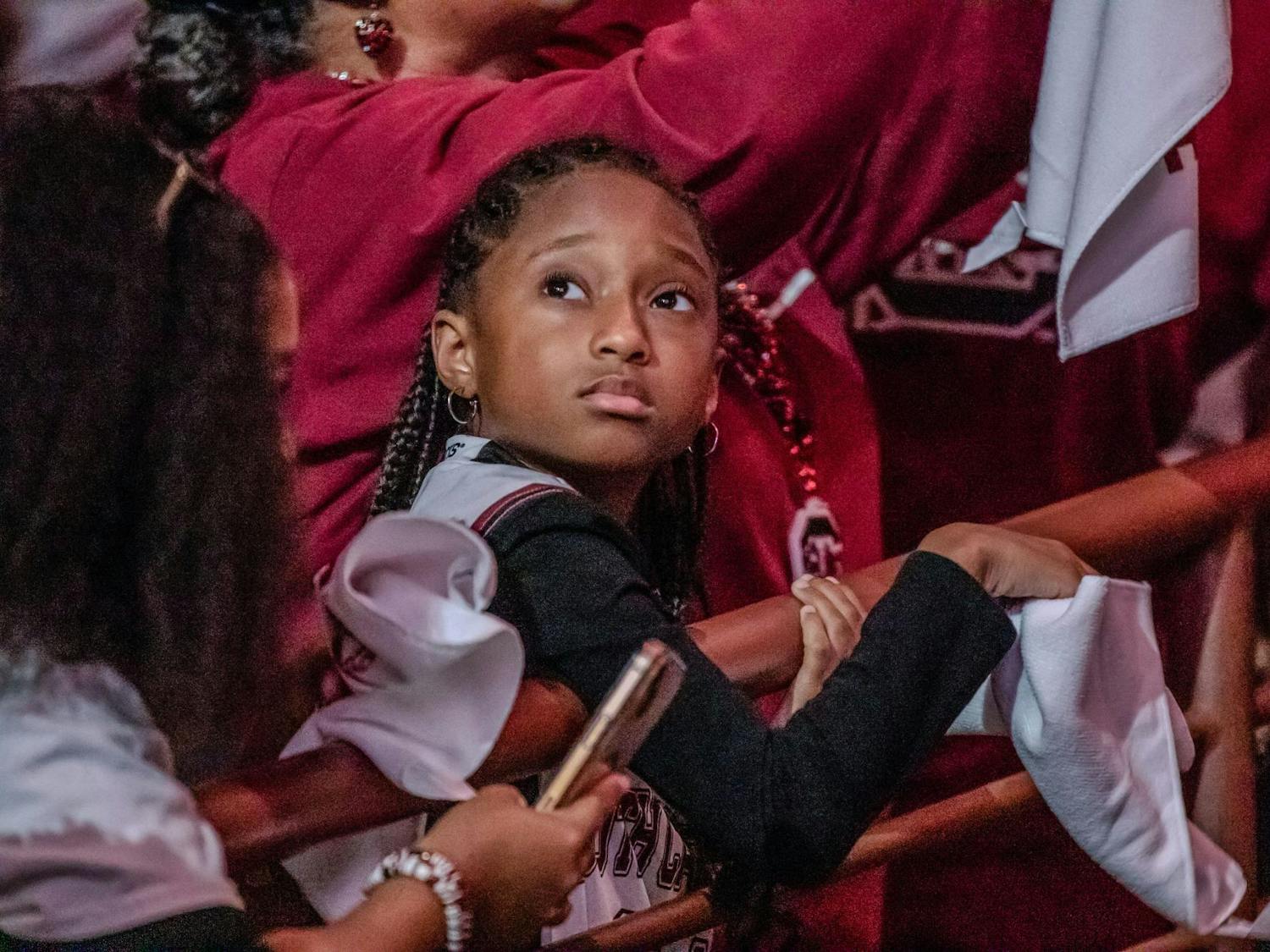 A young Gamecock fan looks toward the video board prior to the start of a welcome home celebration for the 2024 National Champion South Carolina Women's Basketball team at Colonial Life Arena on April 8, 2024. An estimated 18.7 million viewers tuned in to watch the Gamecocks' 87-75 victory over the Iowa Hawkeyes.