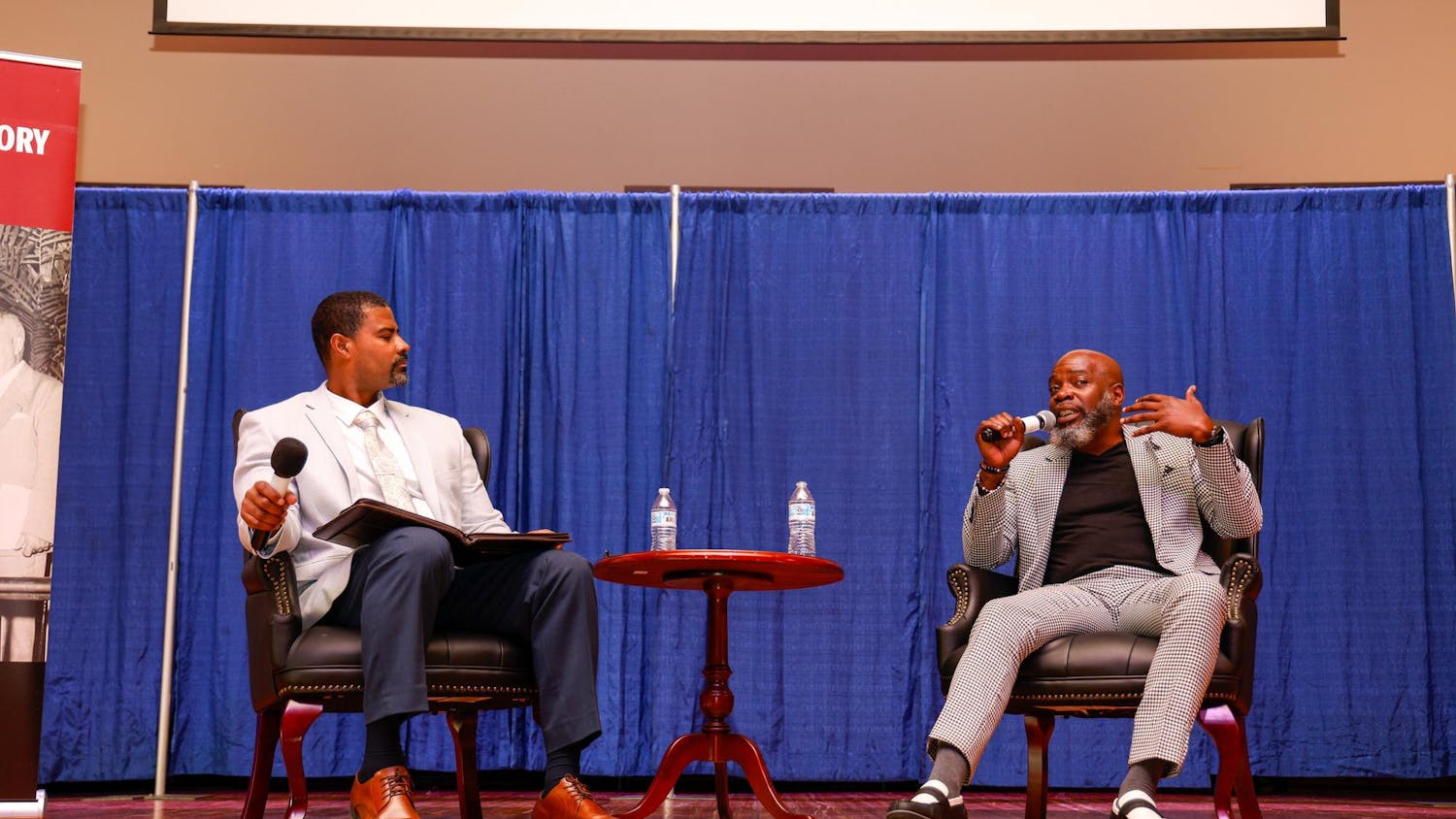 Director of the USC School of Journalism and Mass Communications Damion Waymer and author Michael Harriot speak during "An Evening with Michael Harriot" at Allen College on March 27, 2025. Harriot spoke about his recent book "Black AF History: The Un-Whitewashed History of America".