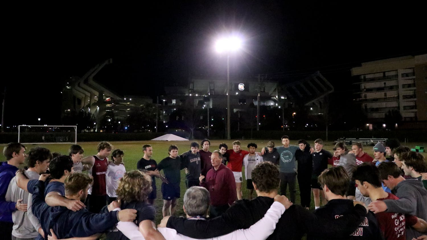 The Gamecock men’s rugby team gathers around head coach John Roberts at the Bluff Road Park practice fields on Feb. 7, 2023. Roberts is an alumnus of the University of South Carolina, and he began coaching the team in November 2021. 
