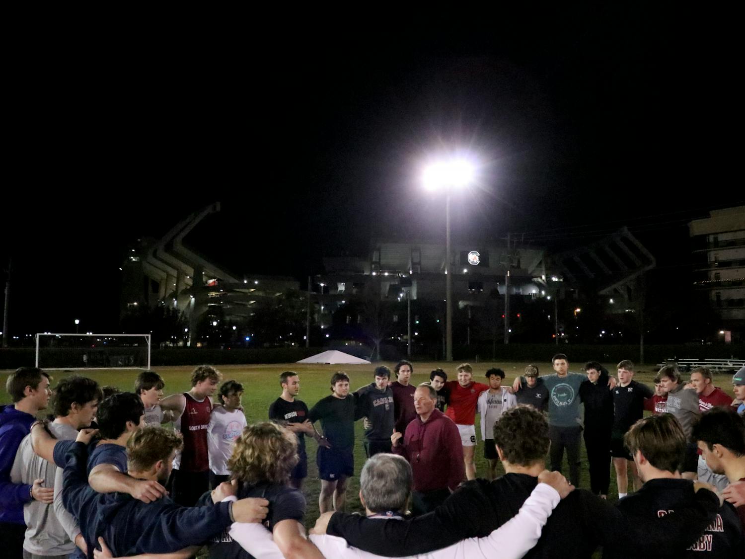 The Gamecock men’s rugby team gathers around head coach John Roberts at the Bluff Road Park practice fields on Feb. 7, 2023. Roberts is an alumnus of the University of South Carolina, and he began coaching the team in November 2021.