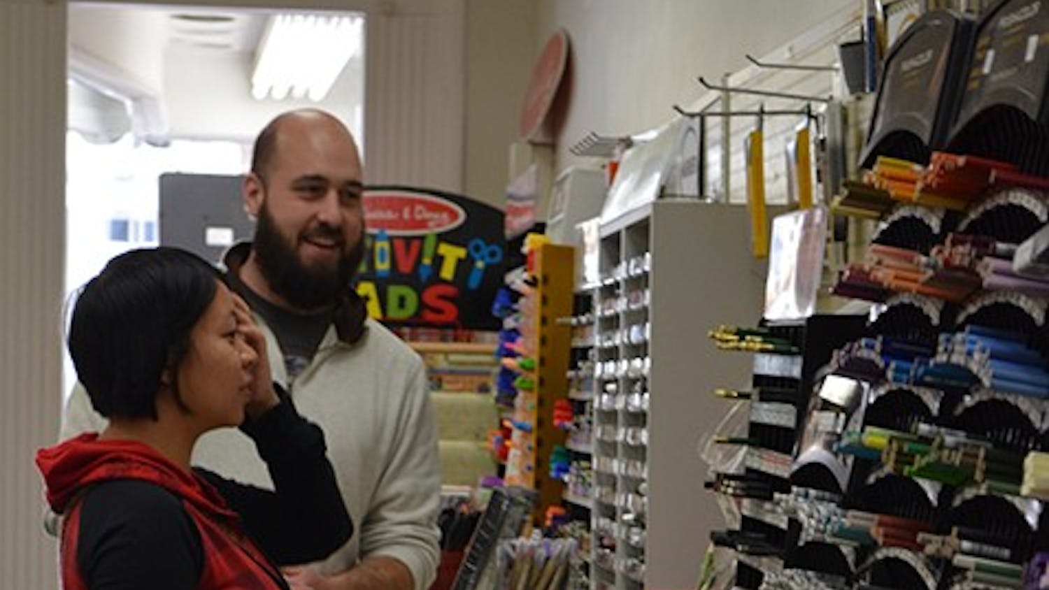 	S&amp;S Art Supply owner Eric Stockard helps a customer choose supplies. The store will close this month.