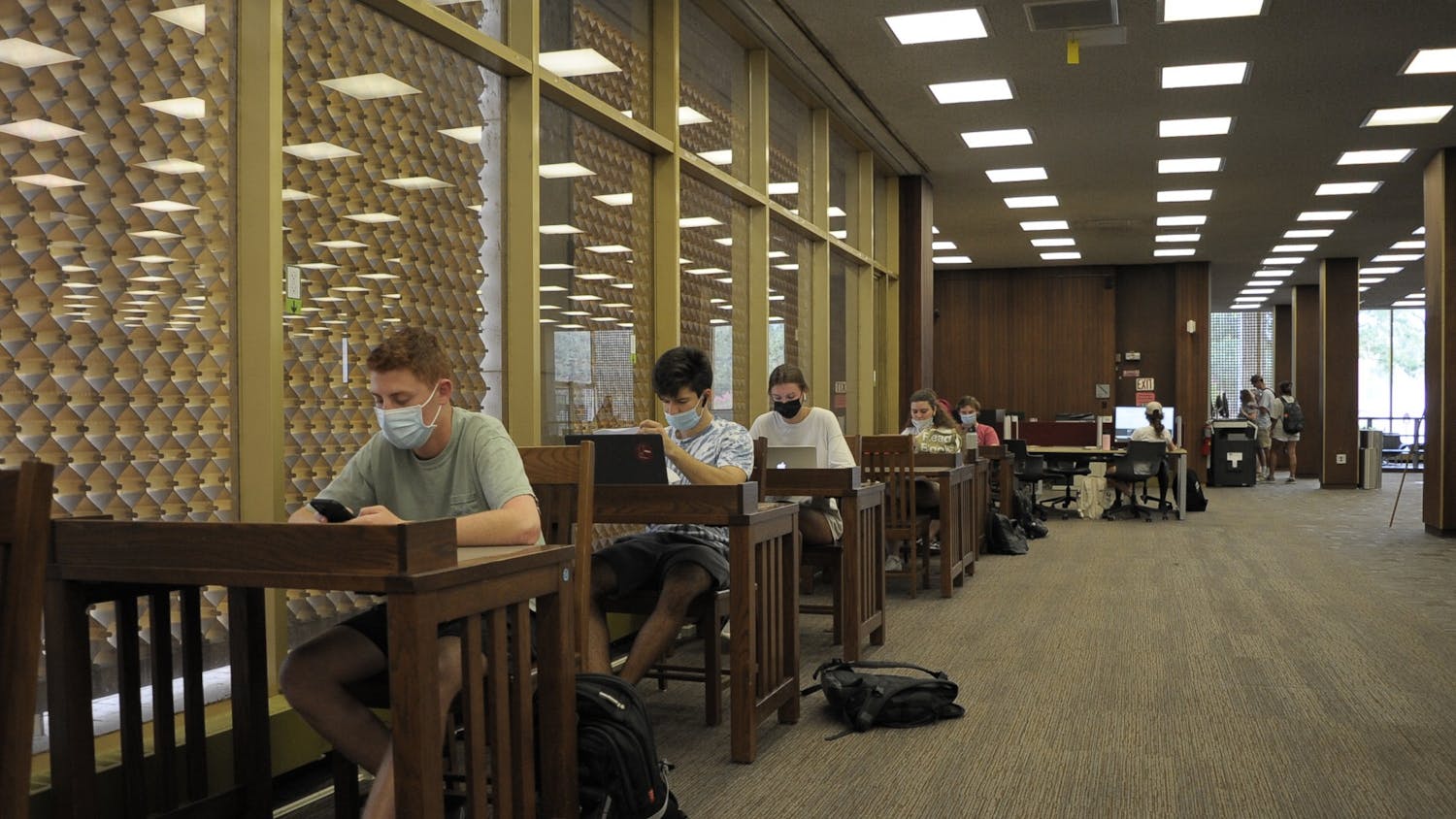 Students sit in USC's Thomas Cooper Library. To follow the university's current mask mandate, students must wear masks in all university buildings and classrooms.&nbsp;