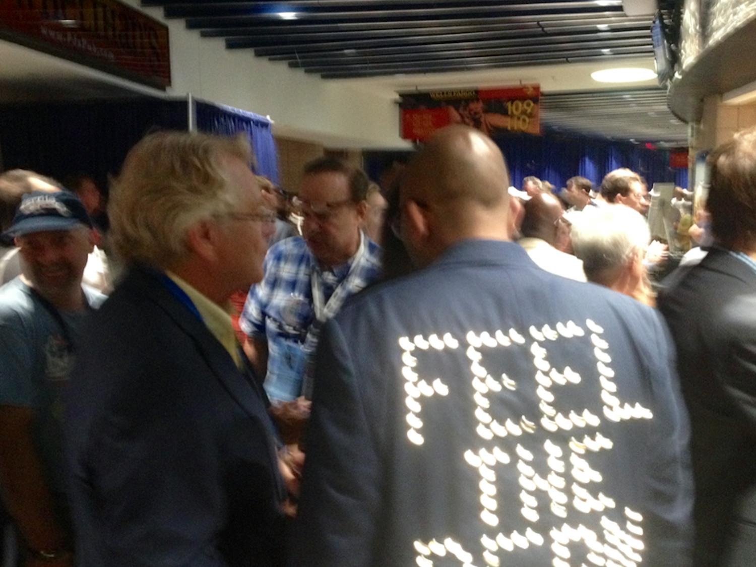Talk show host and former Cincinnati Mayor Jerry Springer chats with a Bernie Sanders delegate on the first day of the Democratic National Convention in Philadelphia on July 25, 2016.