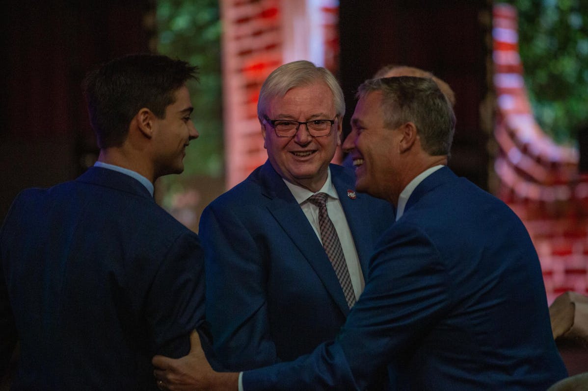 President Michael Amiridis smiled at the camera and Student Body President Patton Byars shook with another person before the State of the Univerisity in Russell House Ballroom.