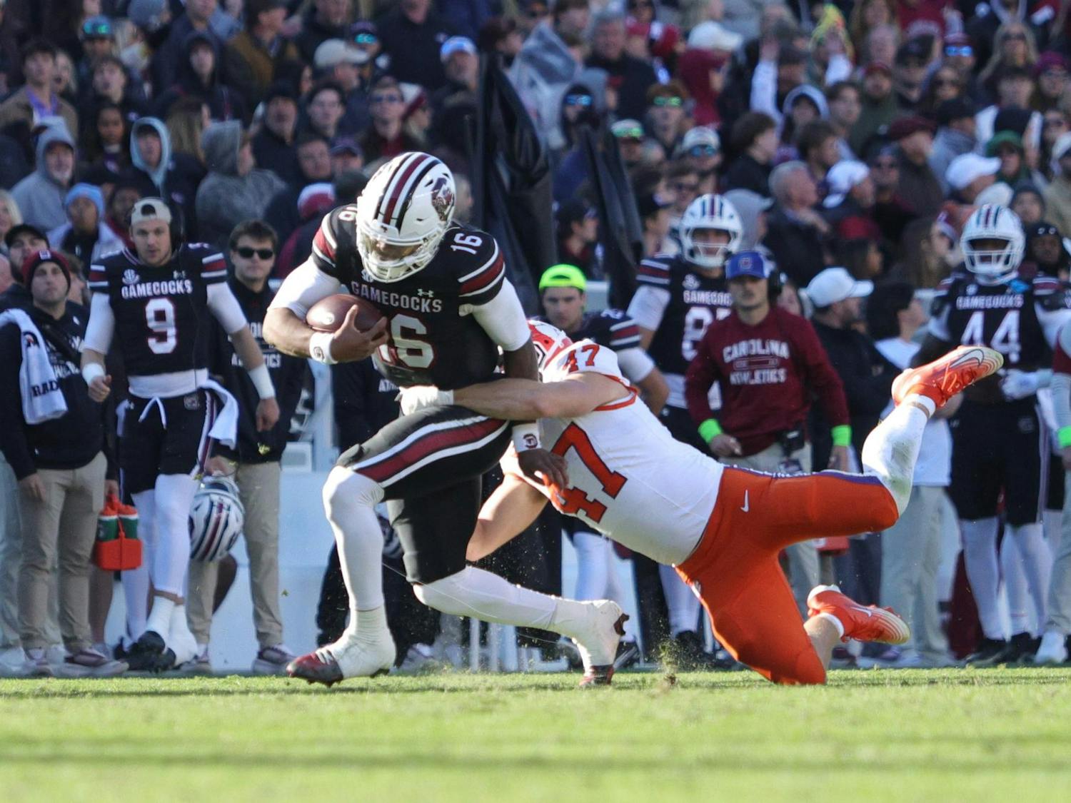 Redshirt sophomore quarterback LaNorris Sellers is taken down while running the ball during South Carolina’s game against Clemson on Nov. 29, 2025, at Williams-Brice Stadium. Sellers fights for extra yards as he’s brought to the turf near the sideline.