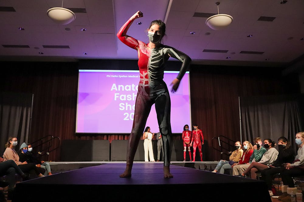 <p>A model, painted with the muscular system on one half of the body and the skeletal system on the other half, walks the runway at the Phi Delta Epsilon's annual Anatomy Fashion Show, an event combining medical education with art to fundraise for the Children's Miracle Network.</p>