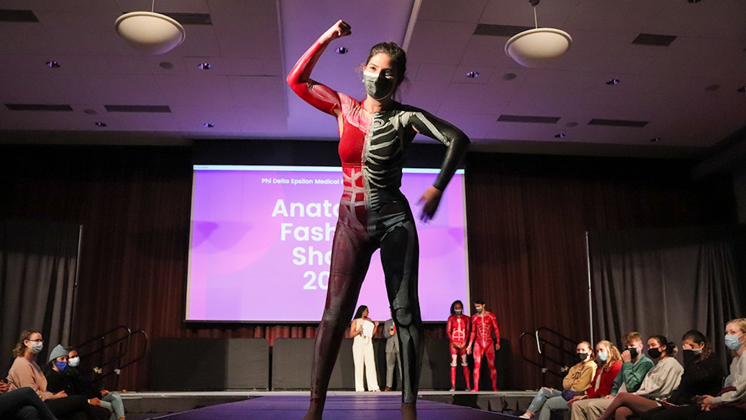 A model, painted with the muscular system on one half of the body and the skeletal system on the other half, walks the runway at the Phi Delta Epsilon's annual Anatomy Fashion Show, an event combining medical education with art to fundraise for the Children's Miracle Network.