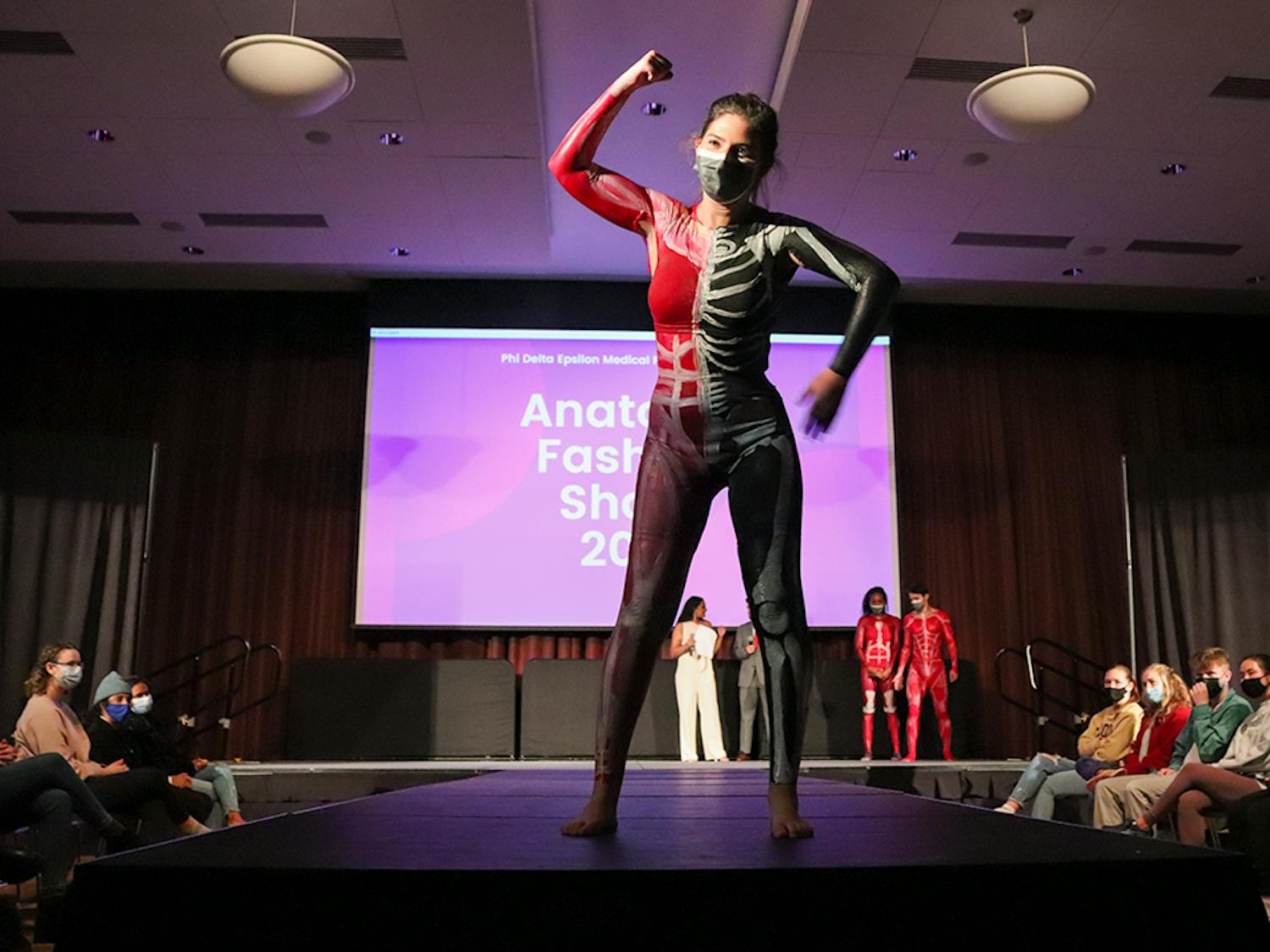 A model, painted with the muscular system on one half of the body and the skeletal system on the other half, walks the runway at the Phi Delta Epsilon's annual Anatomy Fashion Show, an event combining medical education with art to fundraise for the Children's Miracle Network.