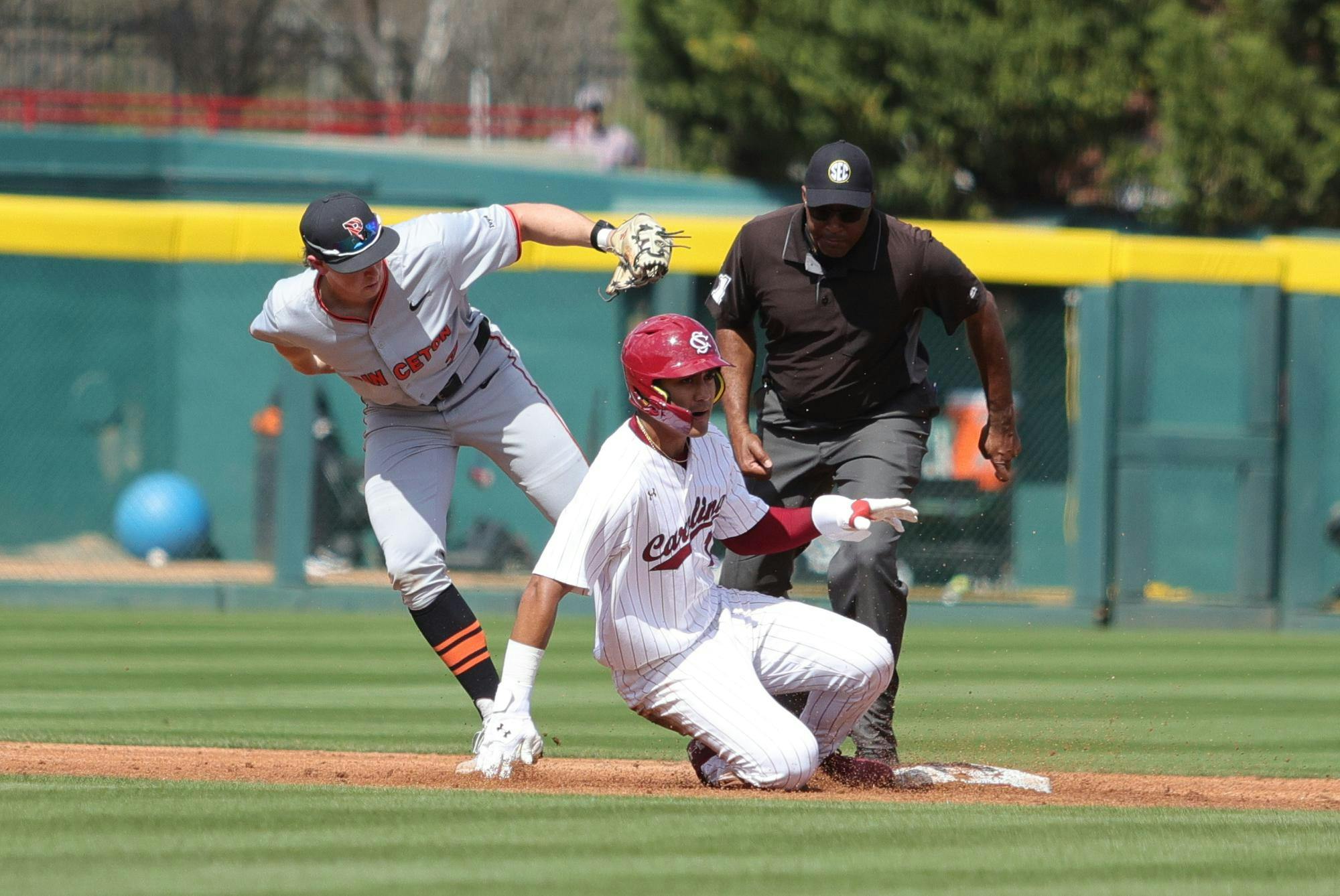 Senior outfielder Ethan Lizama slides into second base during South Carolina’s game against Princeton at Founders Park on March 7, 2026. The umpire watches closely as the play is made at the bag.