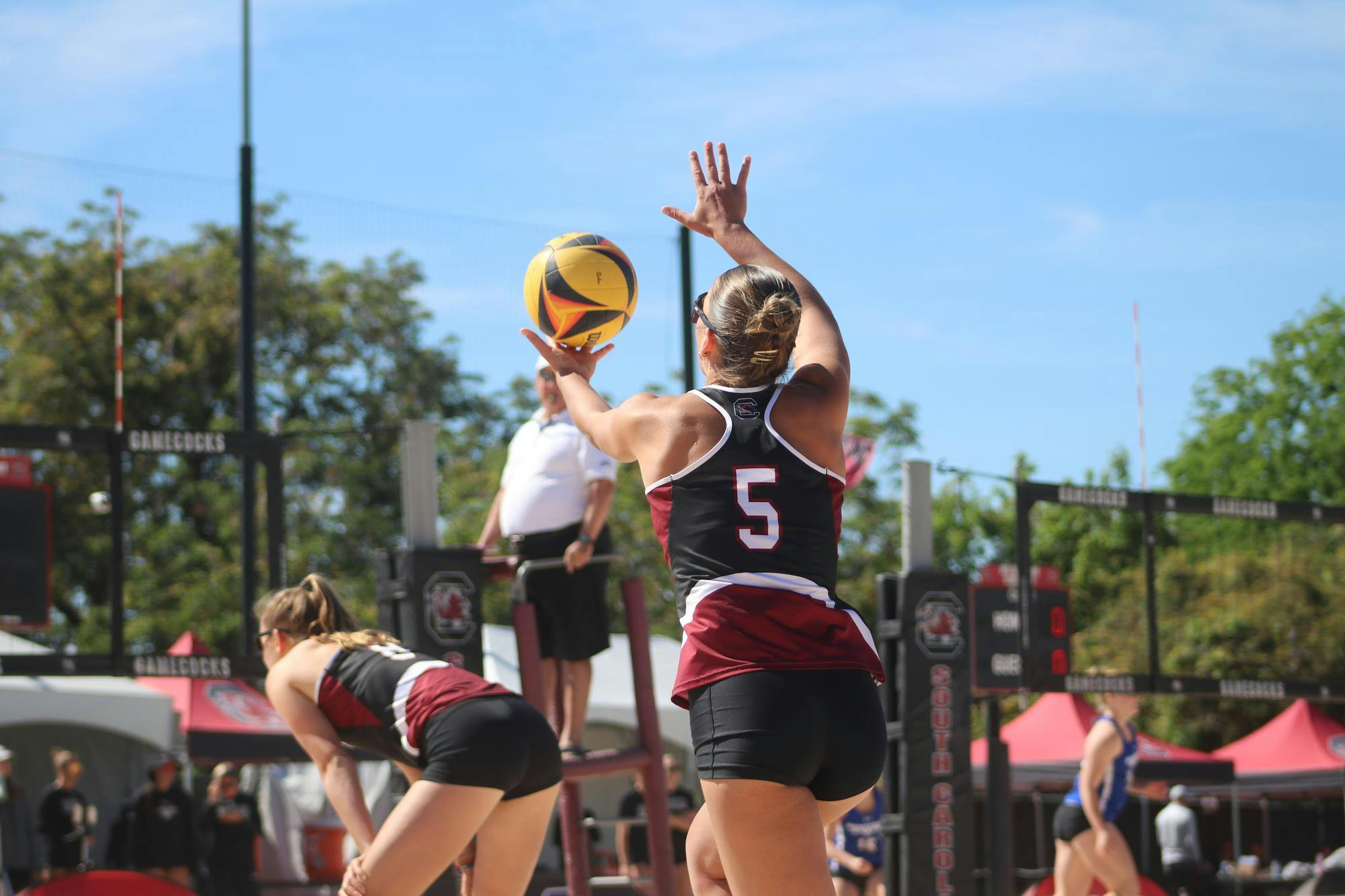 Sophomore Sadie Nelson prepares her serve against Morehead State at Wheeler Beach on April 7, 2024. Nelson and her partner, Kristen Schenck, won both pair matches 21-12 against the Beakers.