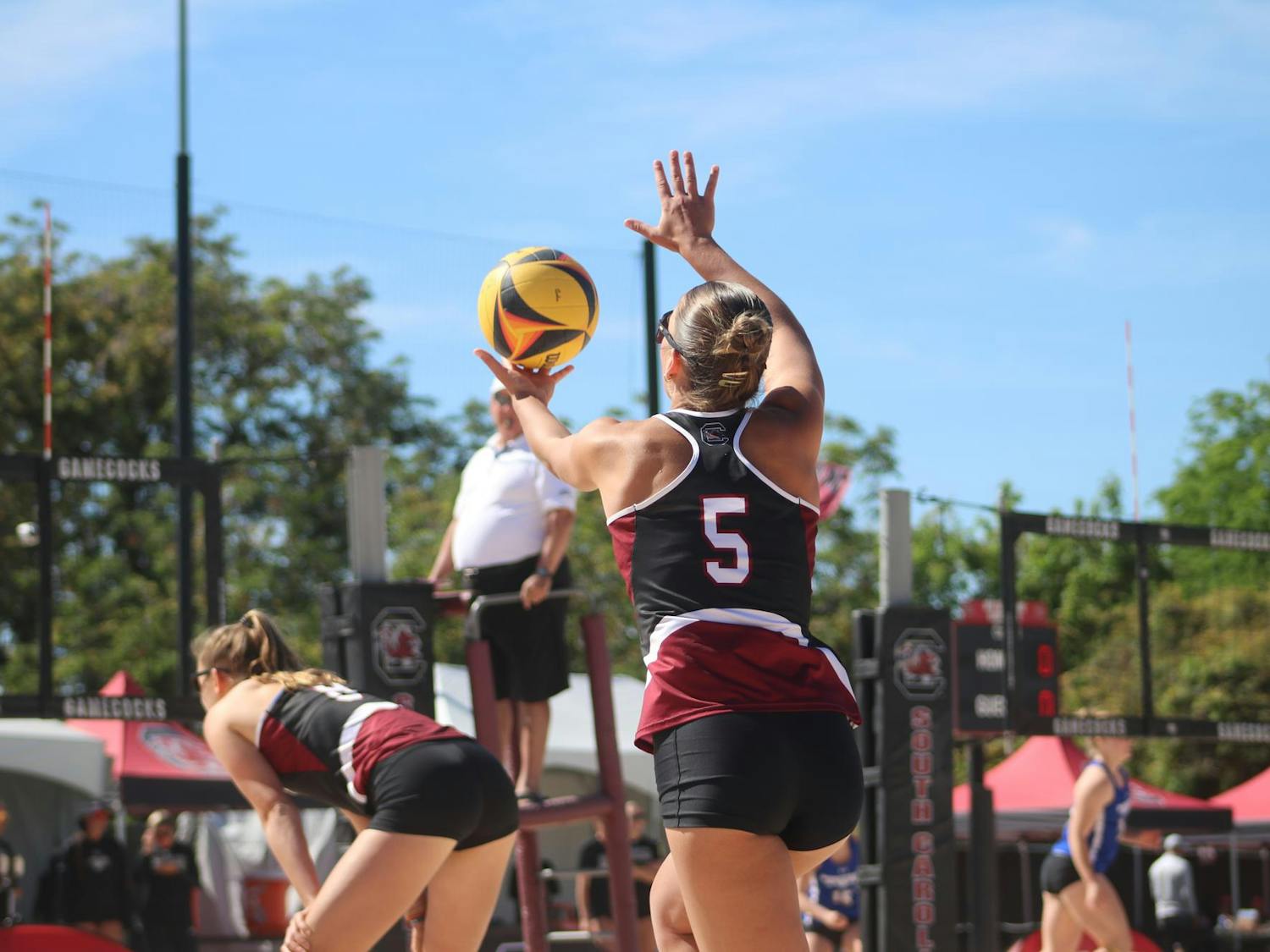 Sophomore Sadie Nelson prepares her serve against Morehead State at Wheeler Beach on April 7, 2024. Nelson and her partner, Kristen Schenck, won both pair matches 21-12 against the Beakers.