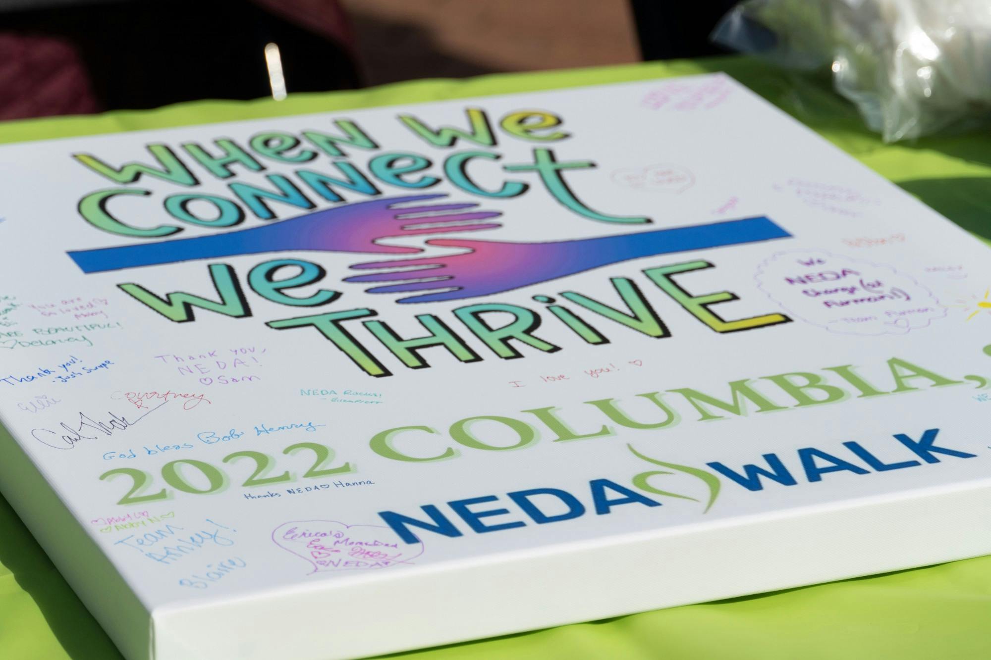 Signable poster board advertising the NEDA Walk on Saturday, 26 2022. The NEDA Walk took place as a charity event raise support and money for those who effected by eating disorders.