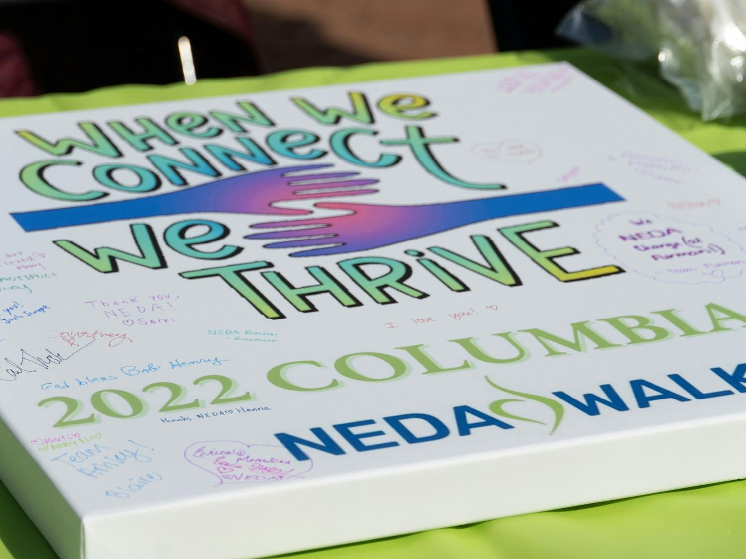 Signable poster board advertising the NEDA Walk on Saturday, 26 2022. The NEDA Walk took place as a charity event raise support and money for those who effected by eating disorders.