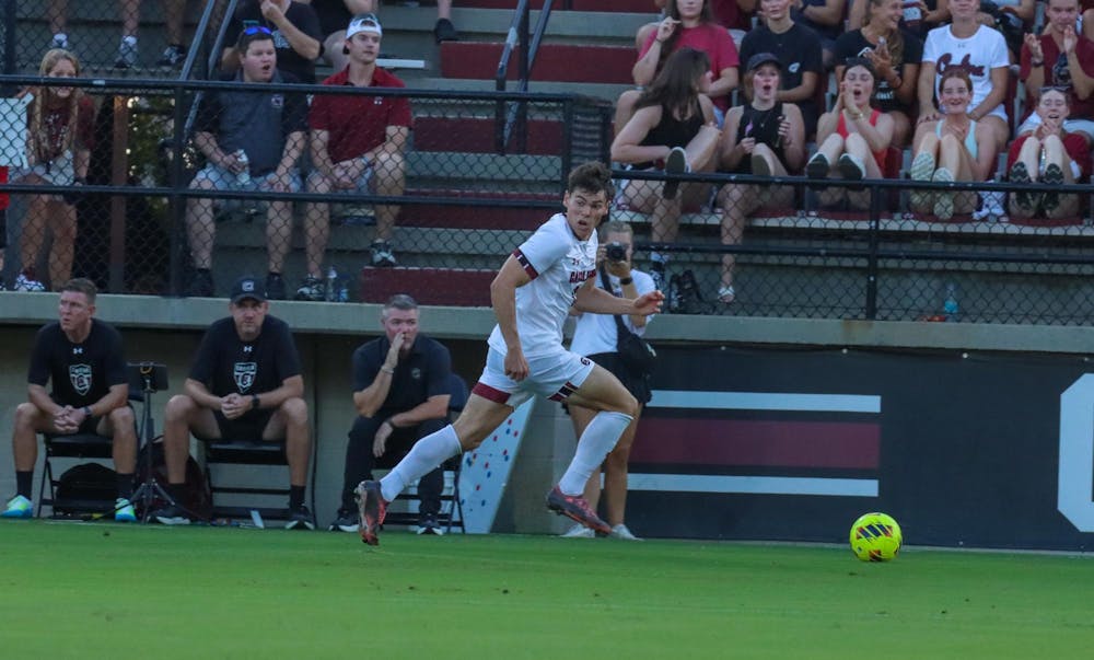 <p>FILE — Junior midfielder Ethan Ballek dribbles the ball down the field against Clemson on Aug. 30, 2024. South Carolina captured its fifth win of the season Tuesday night against Queens. </p>