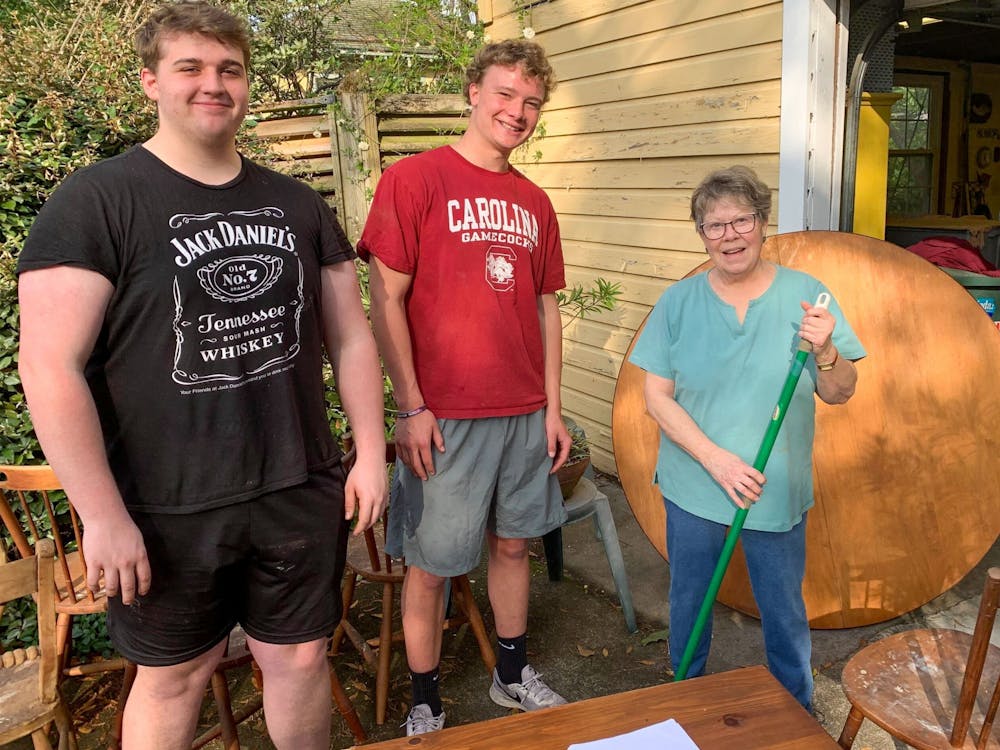 <p>Second-year student Brogan Theobald and first-year student Peter Blackburn assist community member through the rent-a-rugger program on March 13, 2022. Members of the Rugby club has raised approximately $4000 through this program.&nbsp;</p>