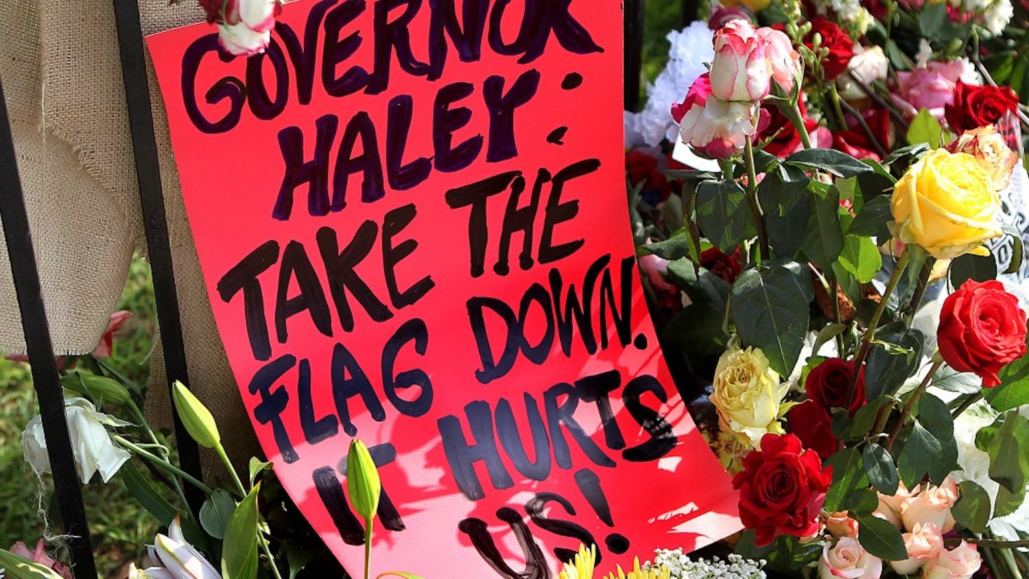 A sign urging South Carolina Gov. Nikki Haley to take down the confederate flag is part of the sidewalk memorial at the "Mother" Emanuel A.M.E. Church on Saturday, June 20, 2015, in Charleston, S.C. (Curtis Compton/Atlanta Journal-Constitution/TNS)
