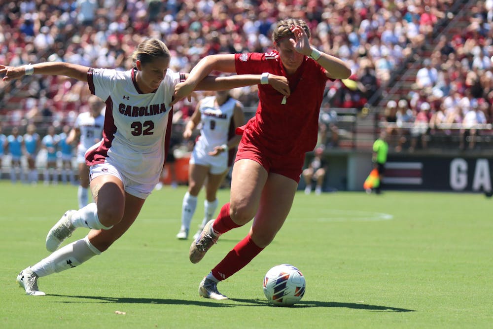 <p>Junior midfielder Cuyler Zulauf attempts to steal a ball against a Miami Ohio player on Aug. 24, 2025 at Stone Stadium. Zulauf attempted a penalty kick, scoring a goal and leading the Gamecocks 2-0 against the Redhawks.</p>